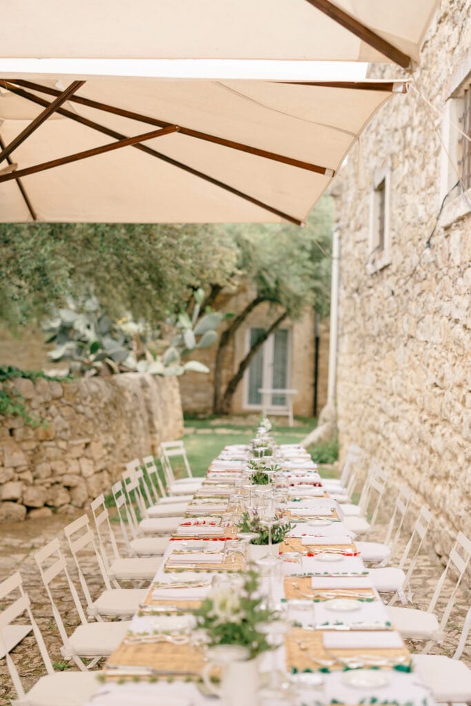 Tavolo del ricevimento lungo il cortile in pietra a Baglio Occhipinti, Vittoria.